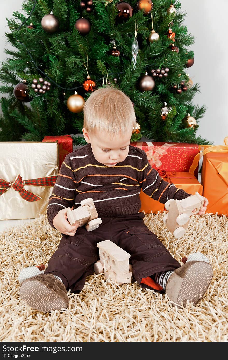 Baby Boy Playing With A Toy At Christmas