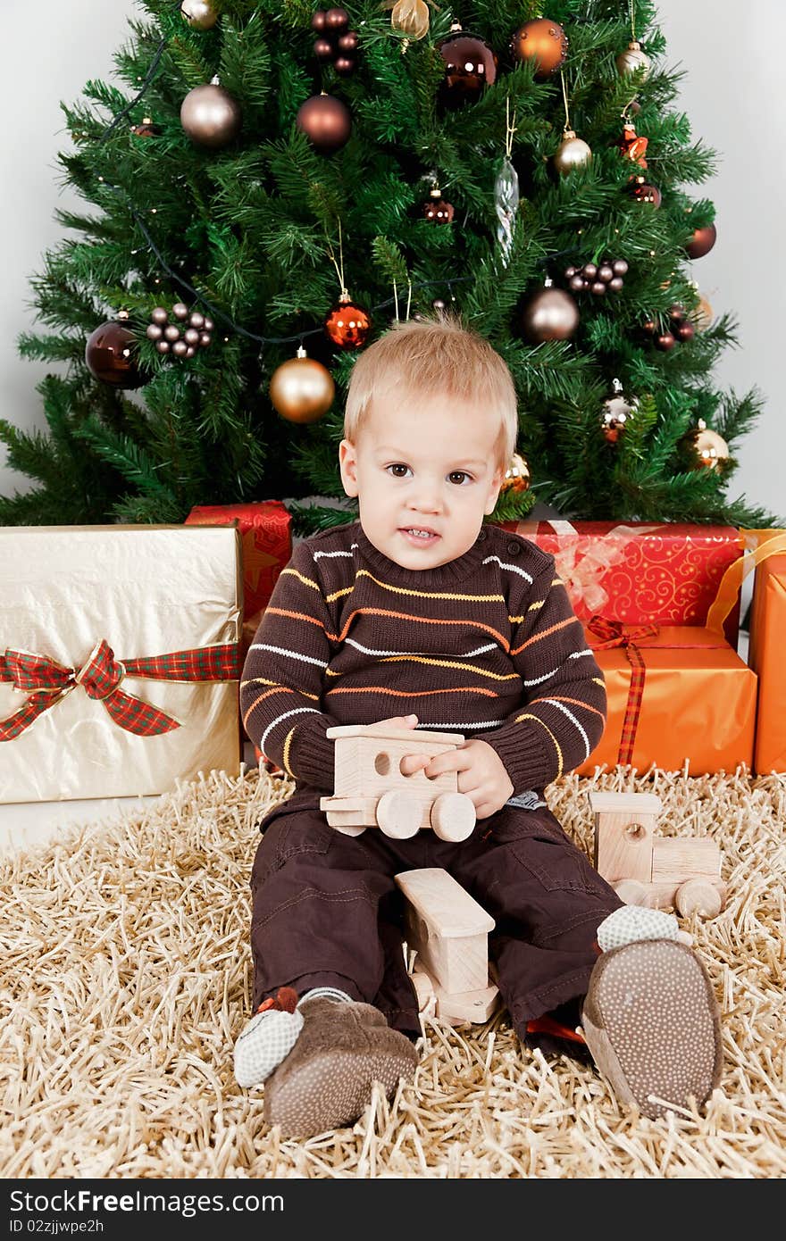 Baby boy playing with a toy at christmas