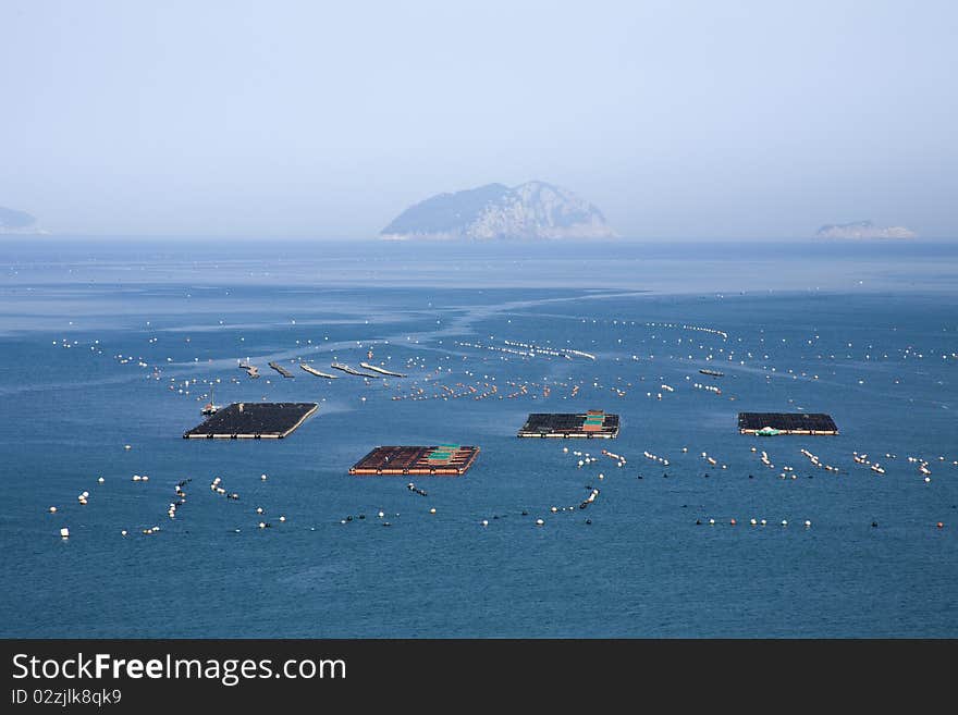 Wide view of fishing farm on calm ocean