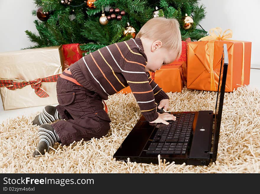 Baby Boy Playing With A Laptop At Christmas