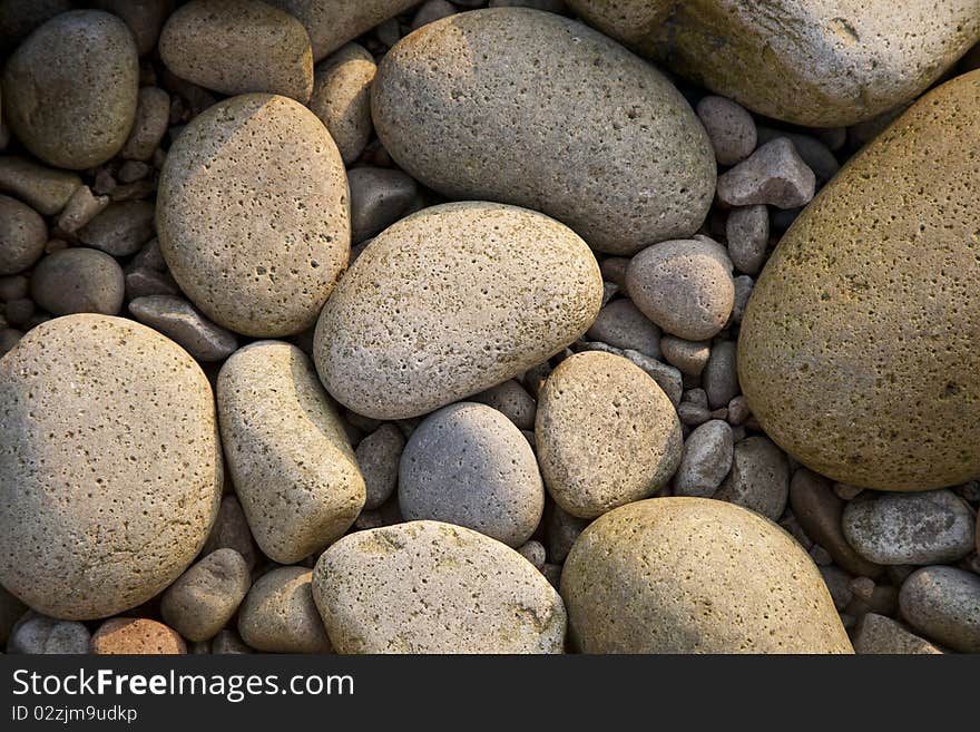 Mossy pebbles on the beach in the evening, outdoor shot