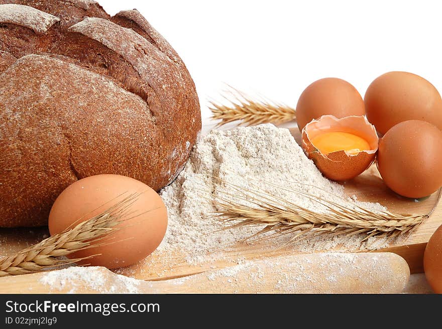 Homemade whole bread and flour on a white background. Homemade whole bread and flour on a white background