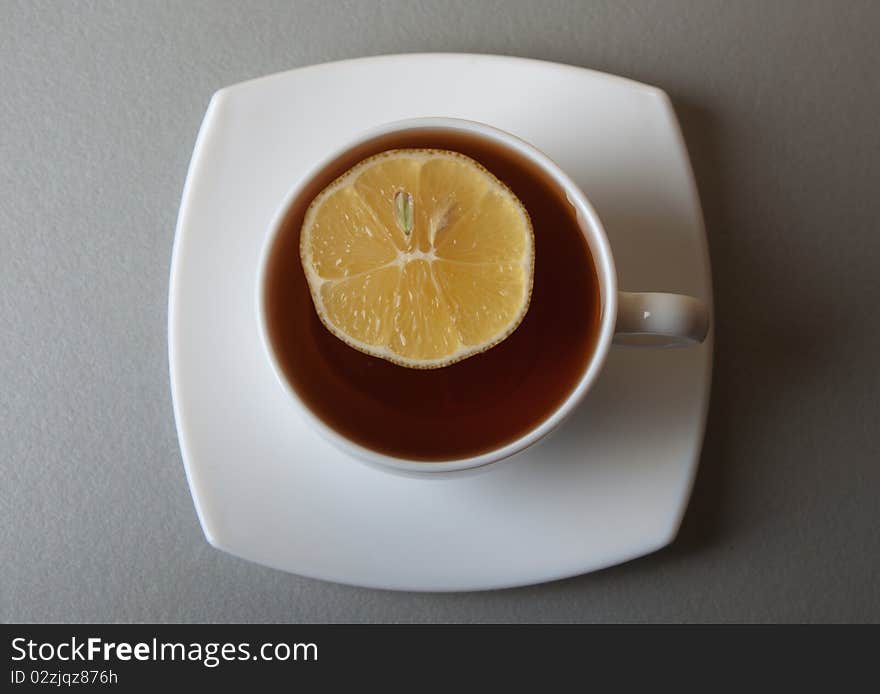Cup of Tea with lemon slice on gray table
