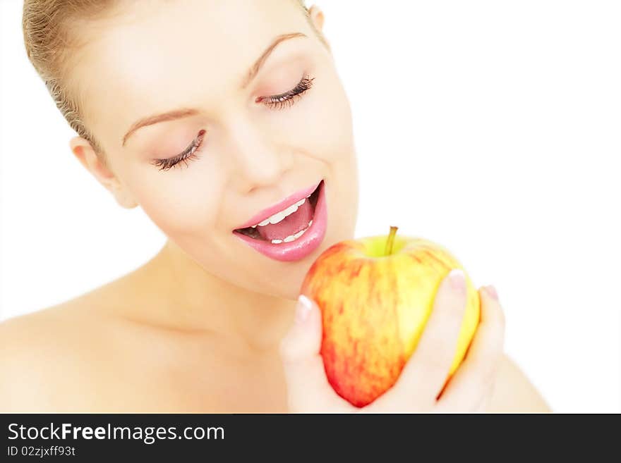 Attractive girl eats an apple isolated on white background