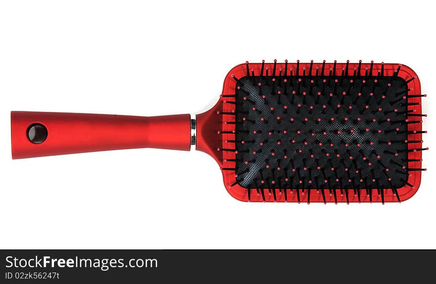 One red massages comb on white background