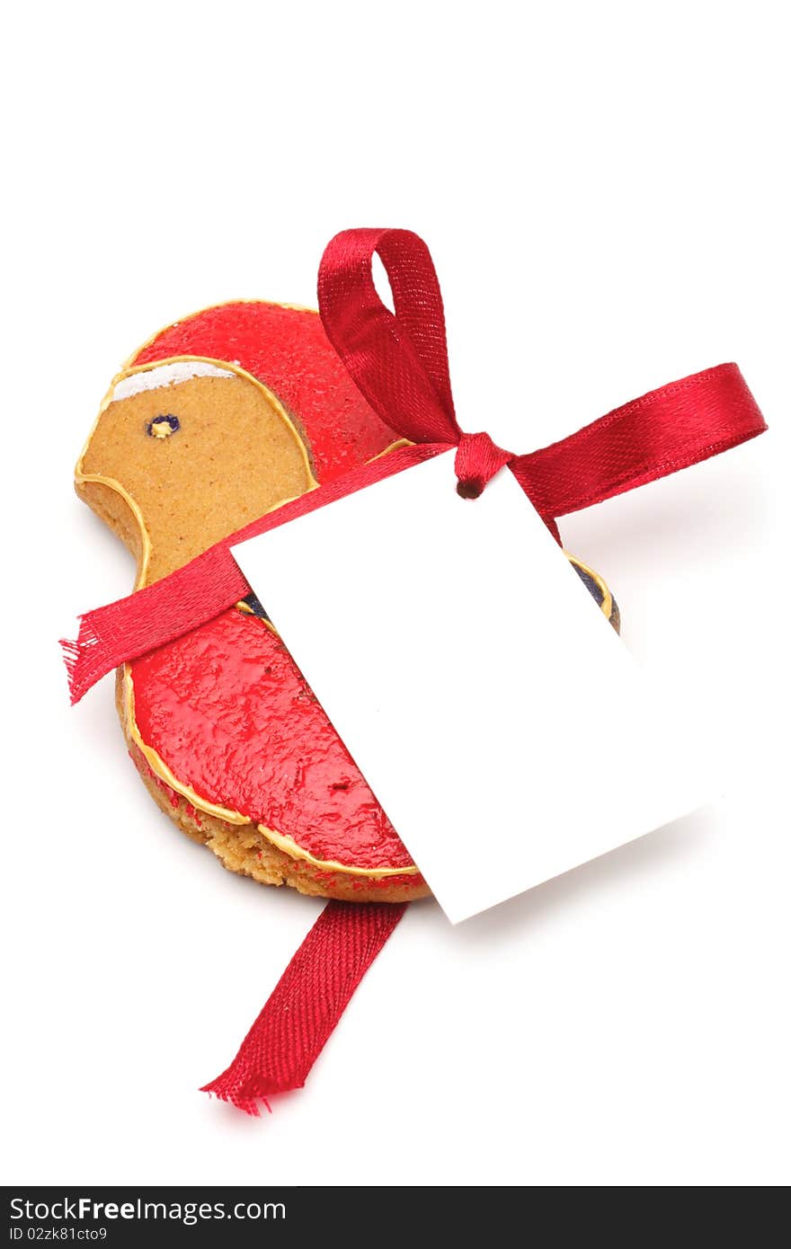 Illustrated Christmas cookies - a bird. Decorated cookies as a gift. A red ribbon tied white cardboard card.Isolated on a white background. Illustrated Christmas cookies - a bird. Decorated cookies as a gift. A red ribbon tied white cardboard card.Isolated on a white background.