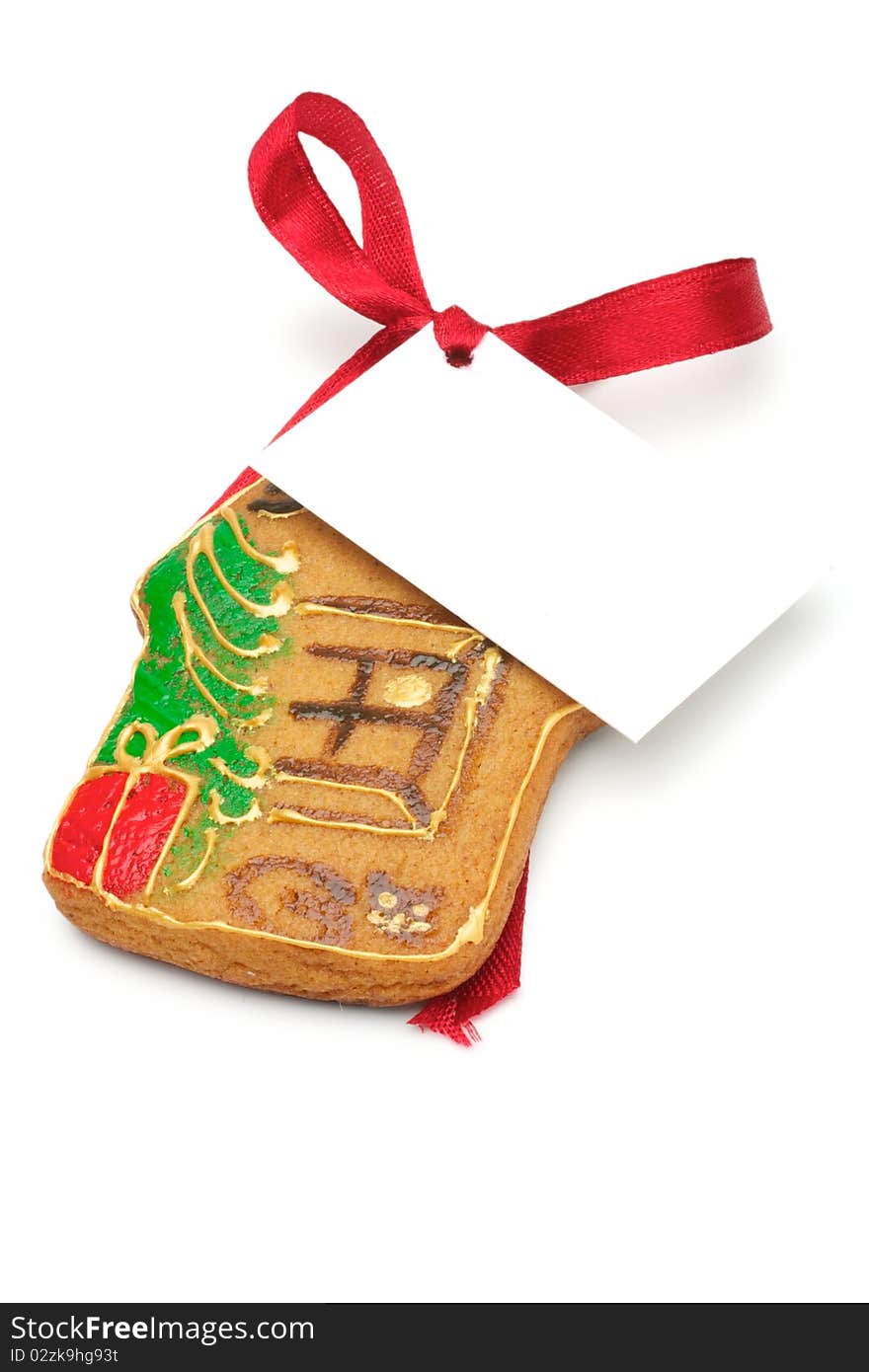 Illustrated Christmas cookies - a house. Decorated cookies as a gift. A red ribbon tied white cardboard card.Isolated on a white background. Illustrated Christmas cookies - a house. Decorated cookies as a gift. A red ribbon tied white cardboard card.Isolated on a white background.