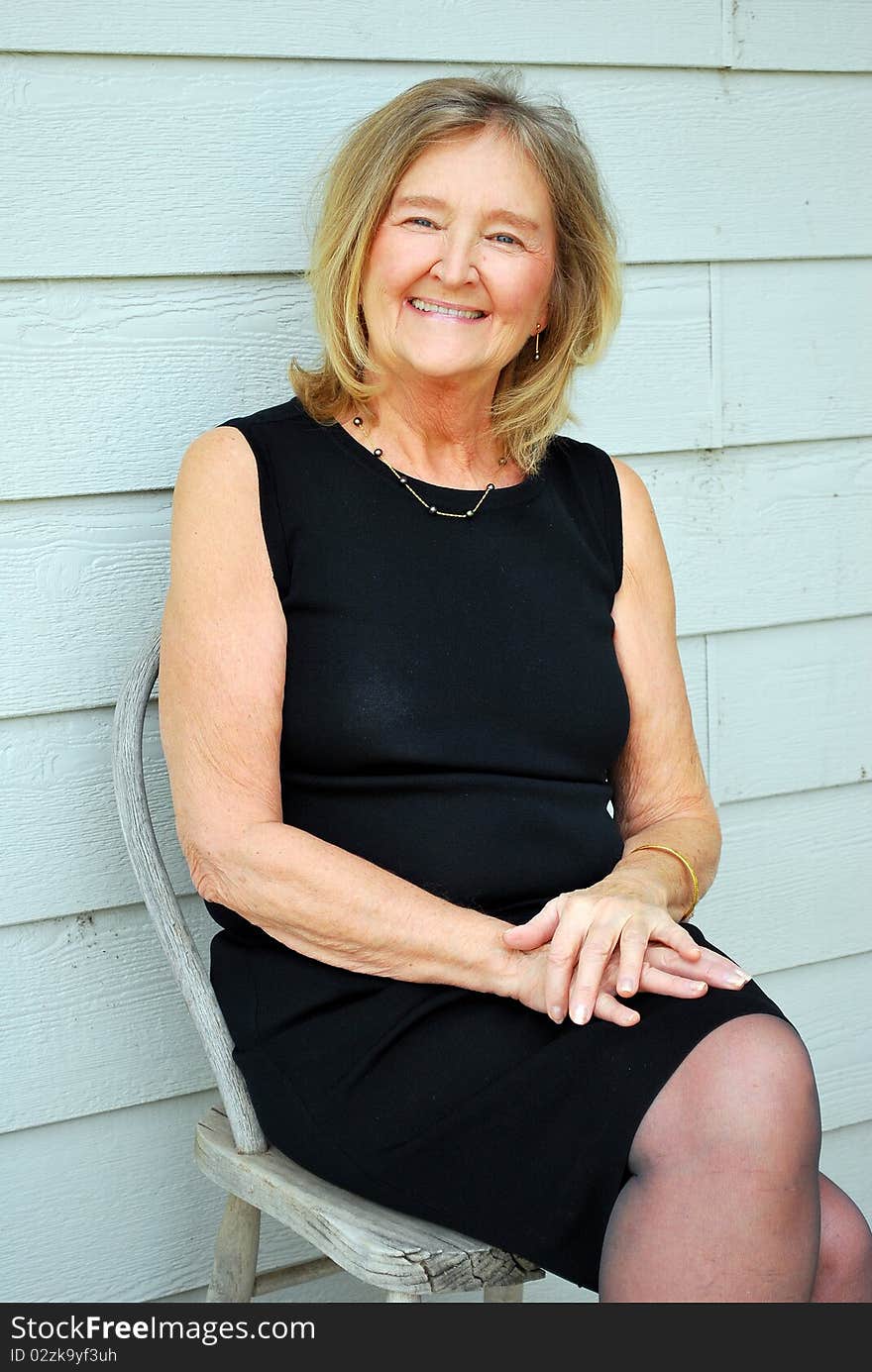 Mature female beauty wearing a little black dress.