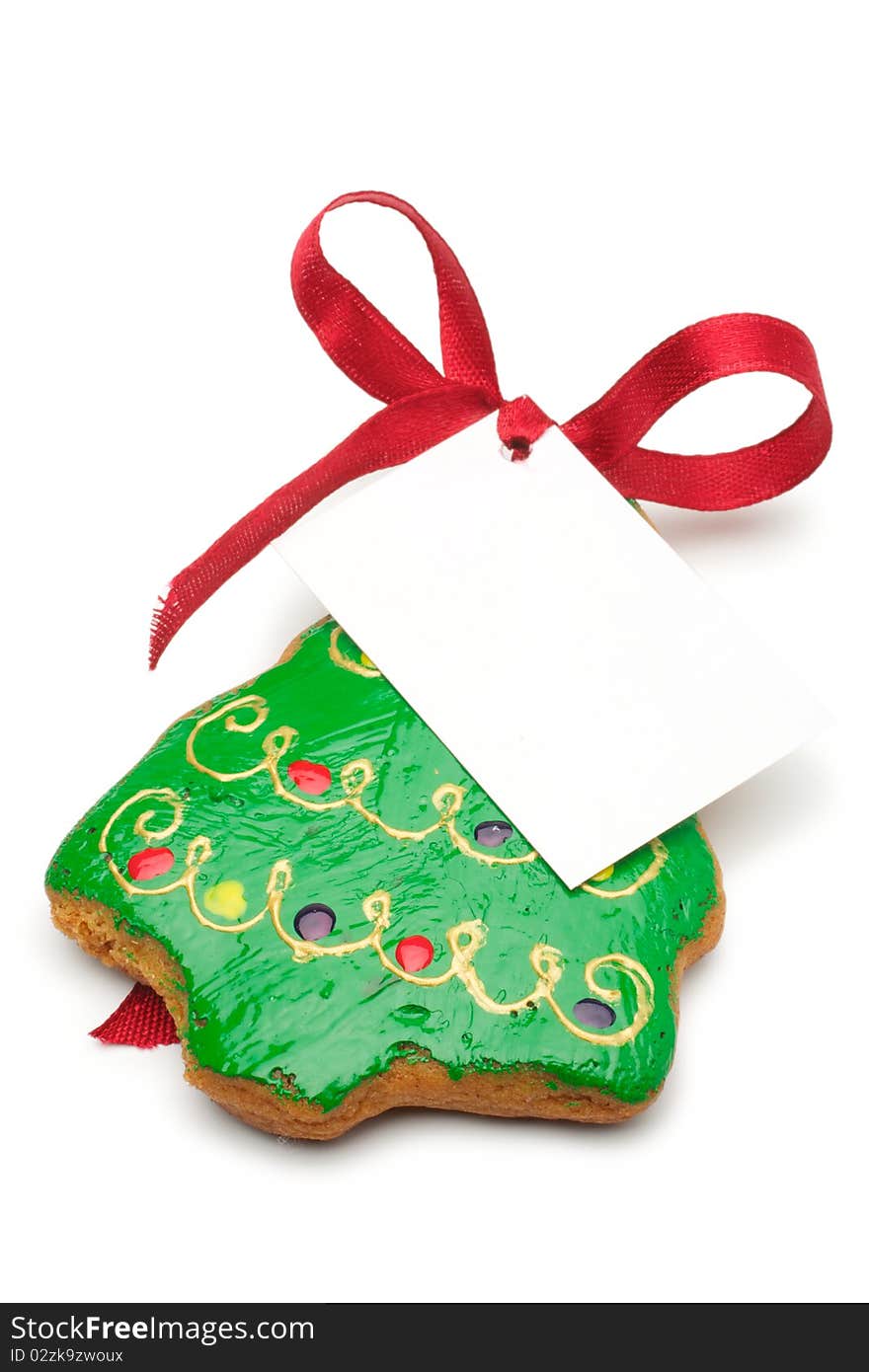 Illustrated Christmas cookies - a Christmas tree. Decorated cookies as a gift. A red ribbon tied white cardboard card.Isolated on a white background. Illustrated Christmas cookies - a Christmas tree. Decorated cookies as a gift. A red ribbon tied white cardboard card.Isolated on a white background.