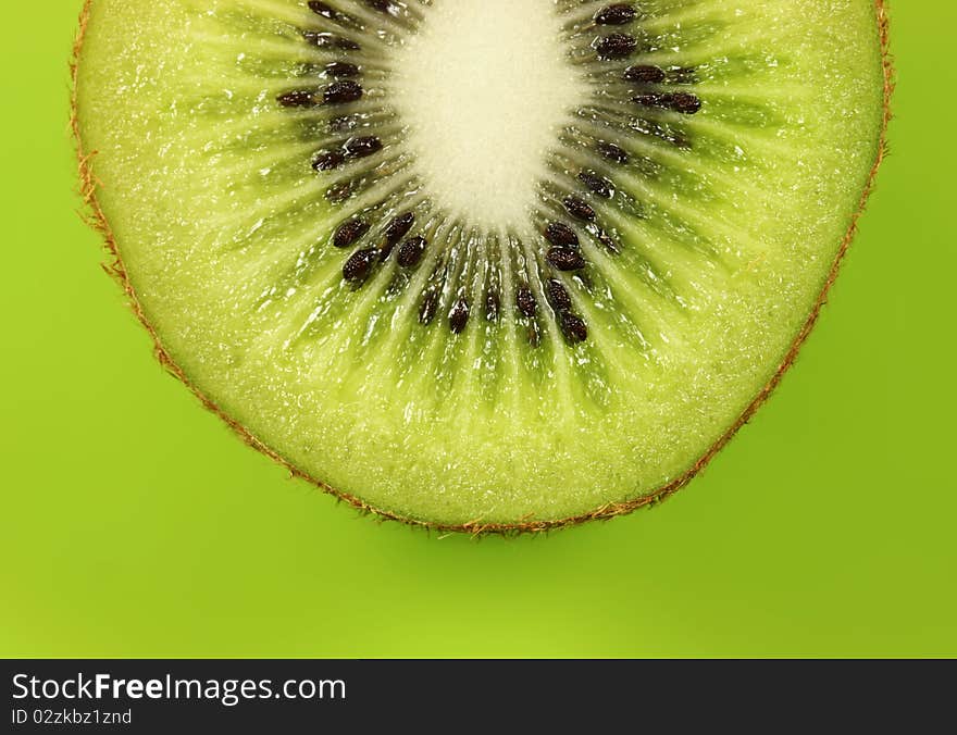 Kiwi half on lush green background. Kiwi half on lush green background.