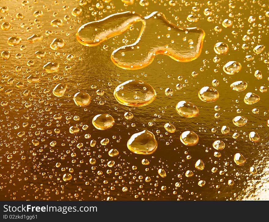 Water drops on golden surface