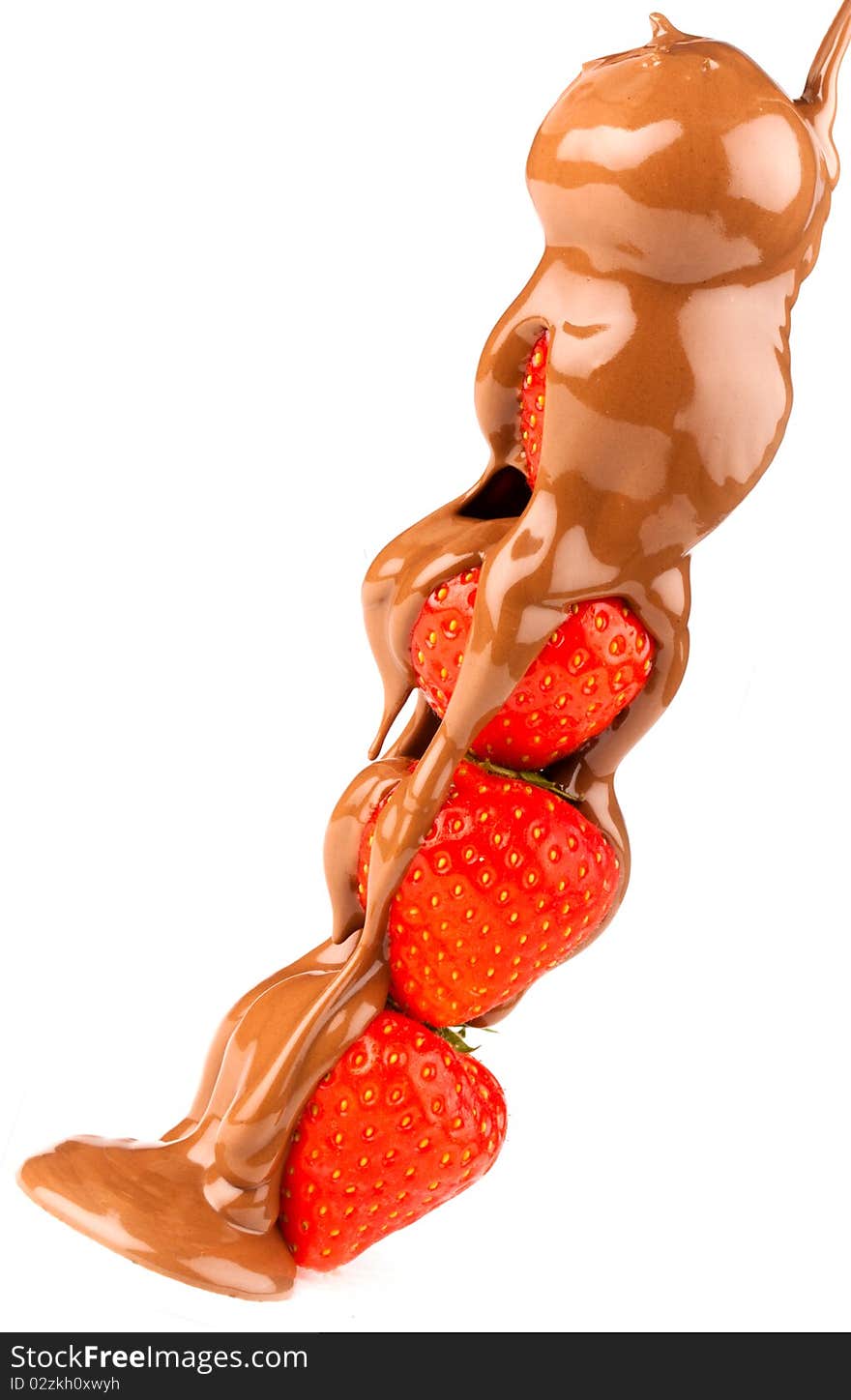 Stack of ripe strawberries with liquid choclate being drizzled over them. Stack of ripe strawberries with liquid choclate being drizzled over them