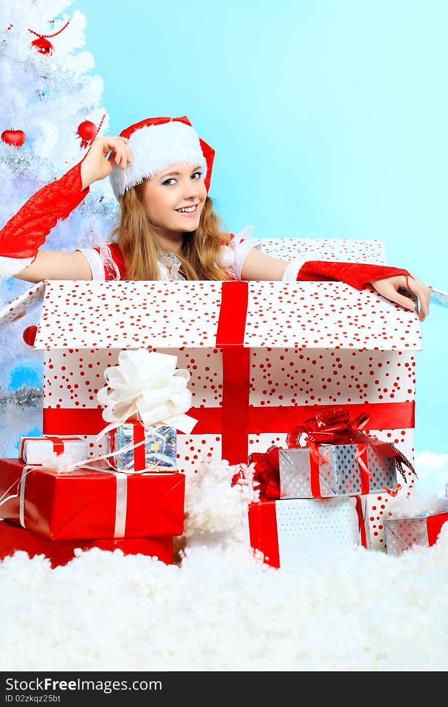 Beautiful young woman in Santa Claus clothes over Christmas background. Beautiful young woman in Santa Claus clothes over Christmas background.