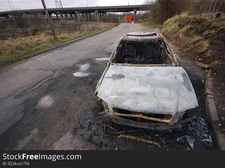 A stolen car, found burnt out in a side street. Taken with a wide angle lens.