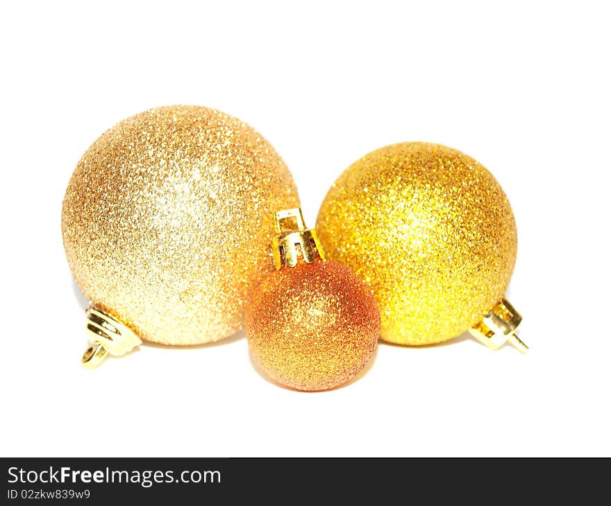 Three gold Christmas balls of different sizes