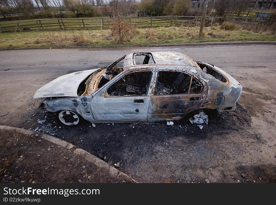 A stolen car, found burnt out in a side street. Taken with a wide angle lens.