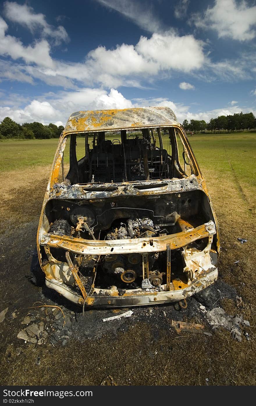 A stolen van, found burnt out on a playing field street. Taken early morning & with a polariser filter.