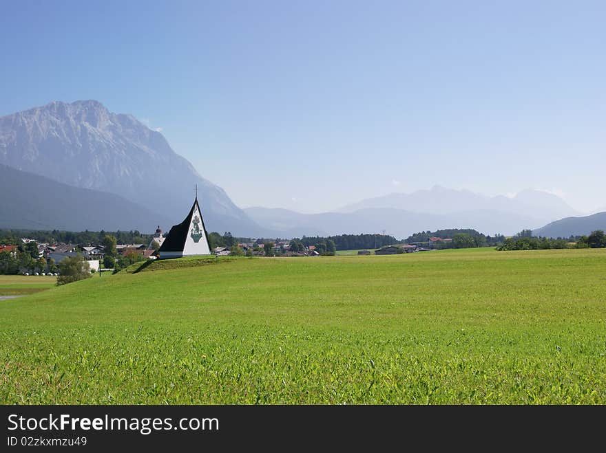 Summer alpine landscape in a misty morning