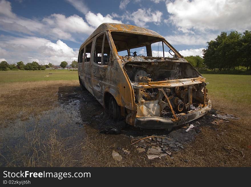 A stolen van, found burnt out on a playing field street. Taken early morning & with a polariser filter.