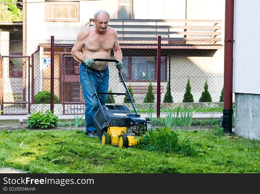 Man cutting grass with the mower