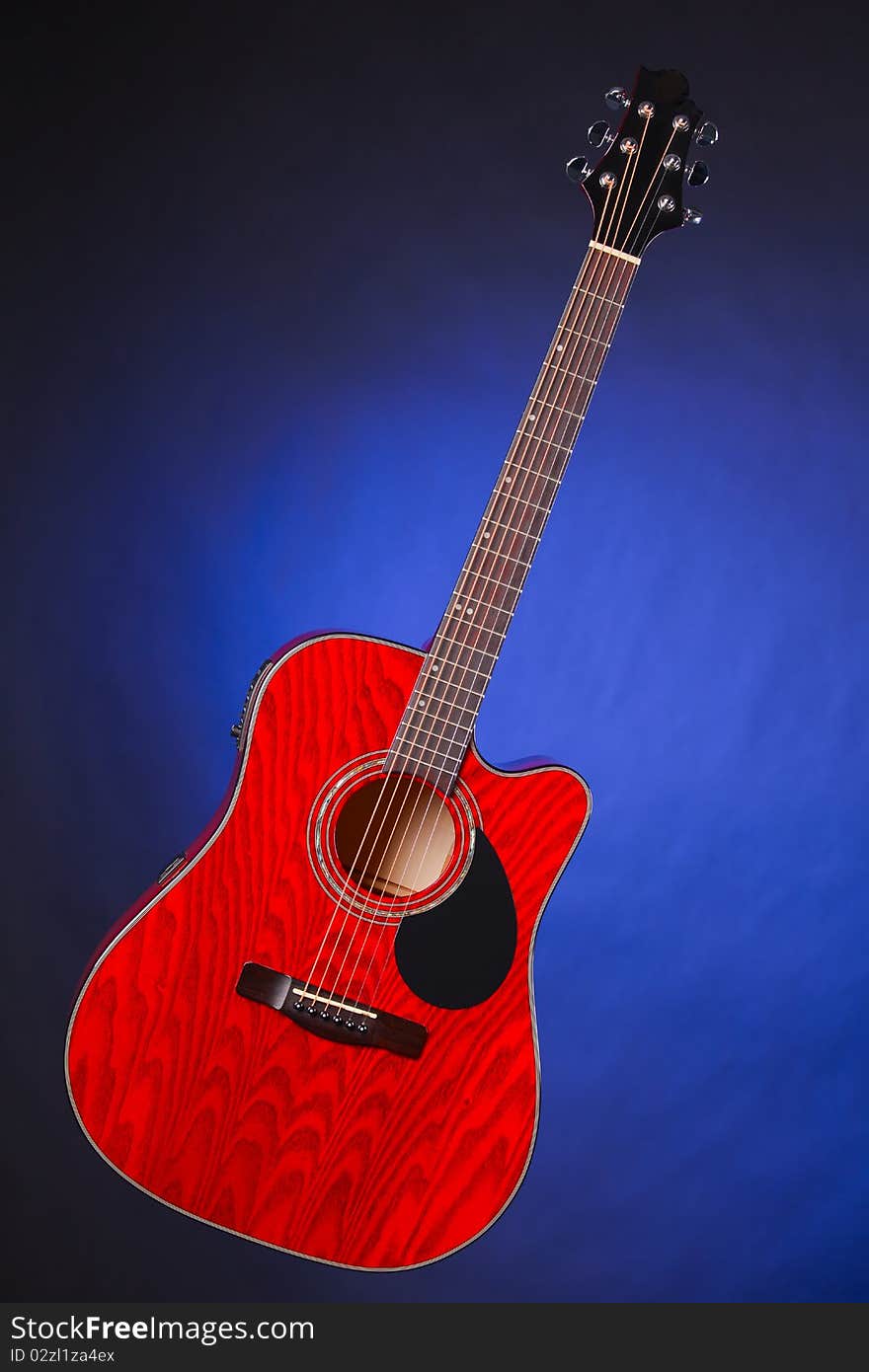 Acoustic Guitar Isolated on Blue