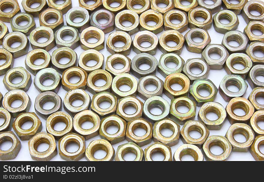 Small metal nuts on a white background a structure