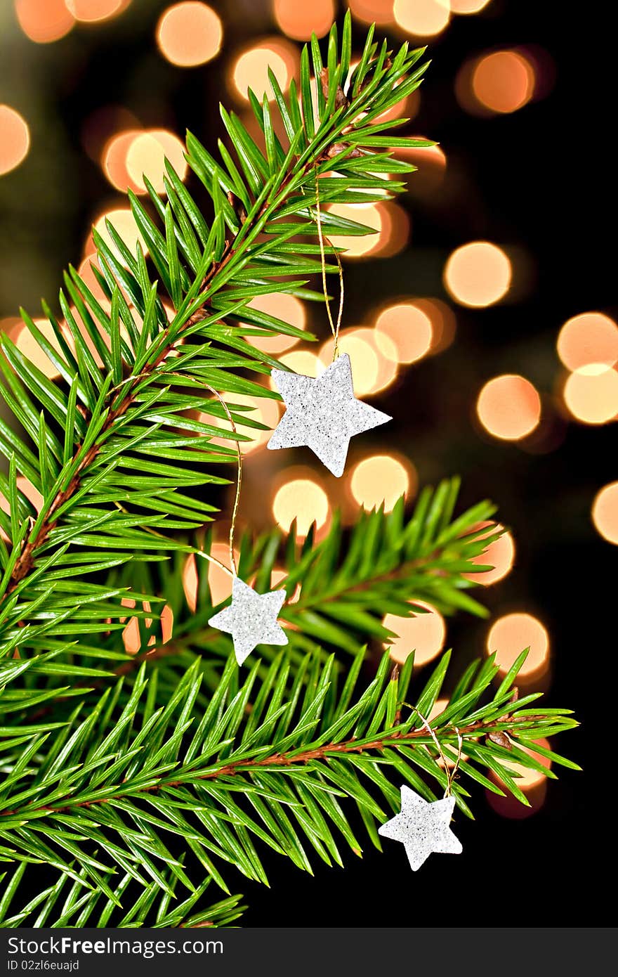 Fir branch with hanging Christmas decorations on a black background. Back background bokhe not photoshop. Fir branch with hanging Christmas decorations on a black background. Back background bokhe not photoshop.