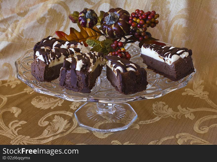 Cheesecake slices on a glass pedestal cake plate