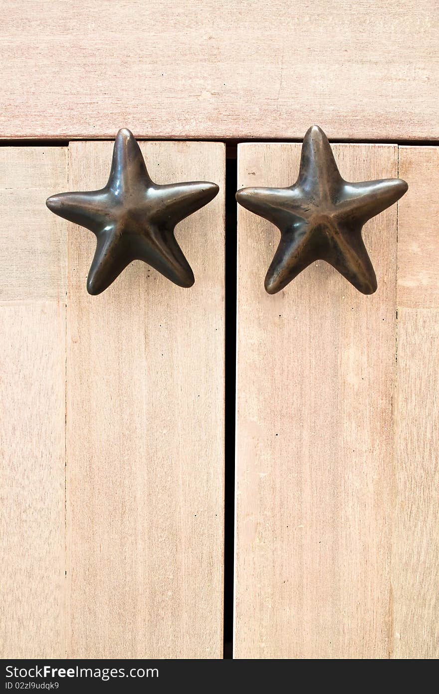 Star shape cabinet handles on wooden cabinet