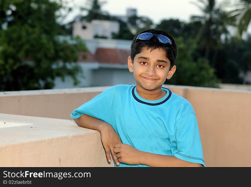 An handsome young Indian kid looking very happy