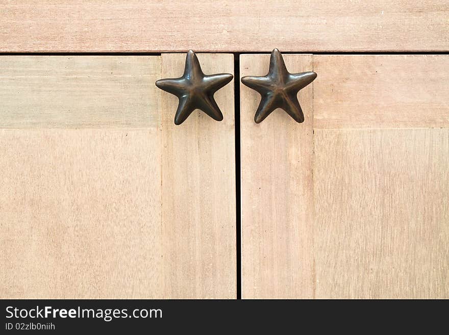 Star shape cabinet handles on wooden cabinet