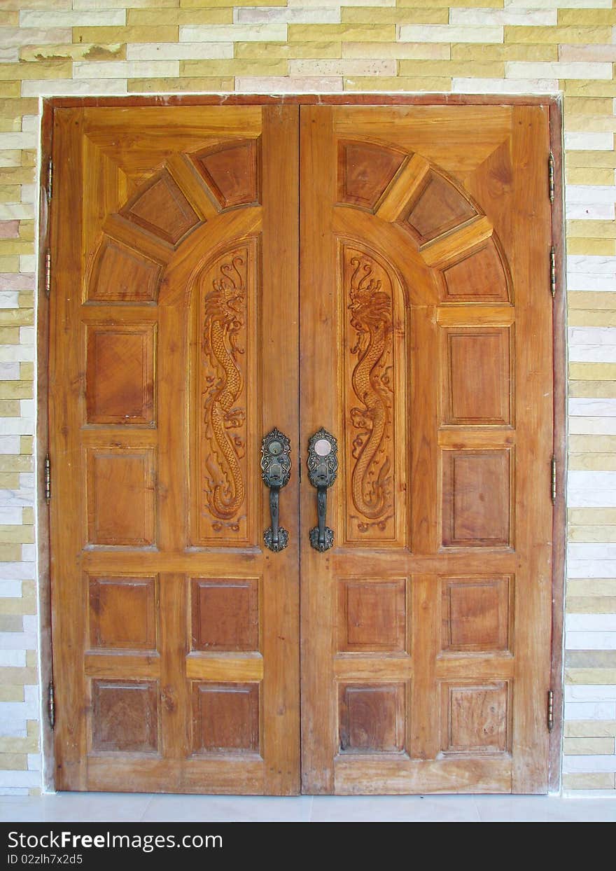 King of Nagas design on brown door of house