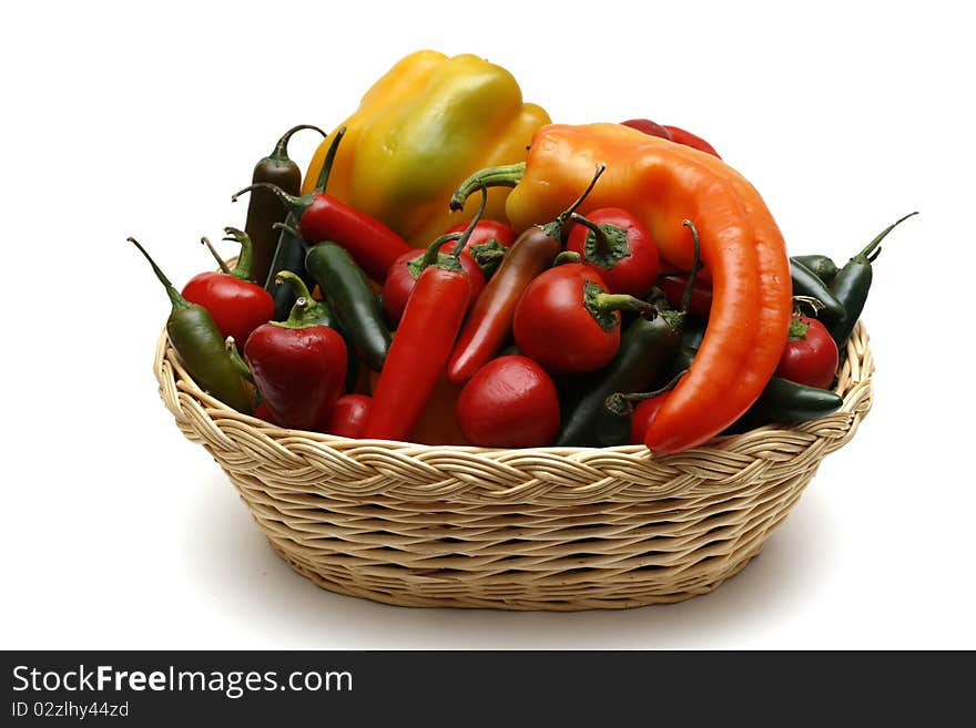 A collection of peppers in a wicker basket