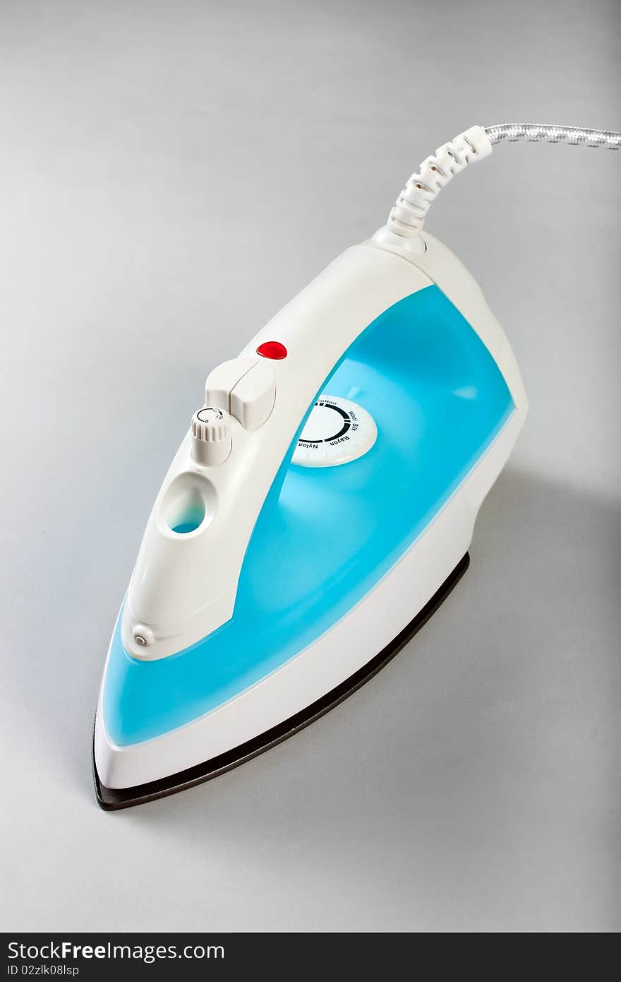 White blue electric steam iron on a white background