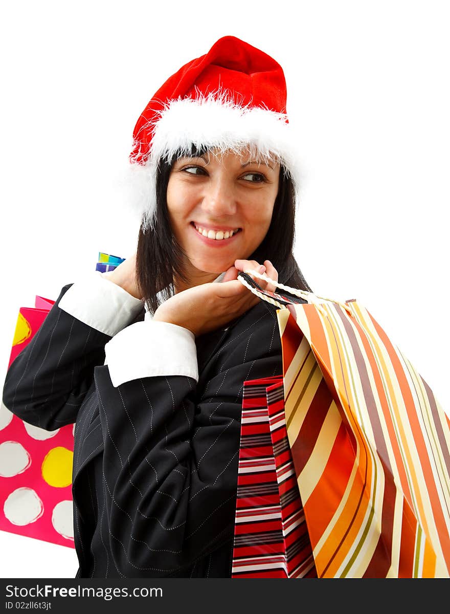 Smiling young businesswoman in santa hat with shopping bags. Smiling young businesswoman in santa hat with shopping bags