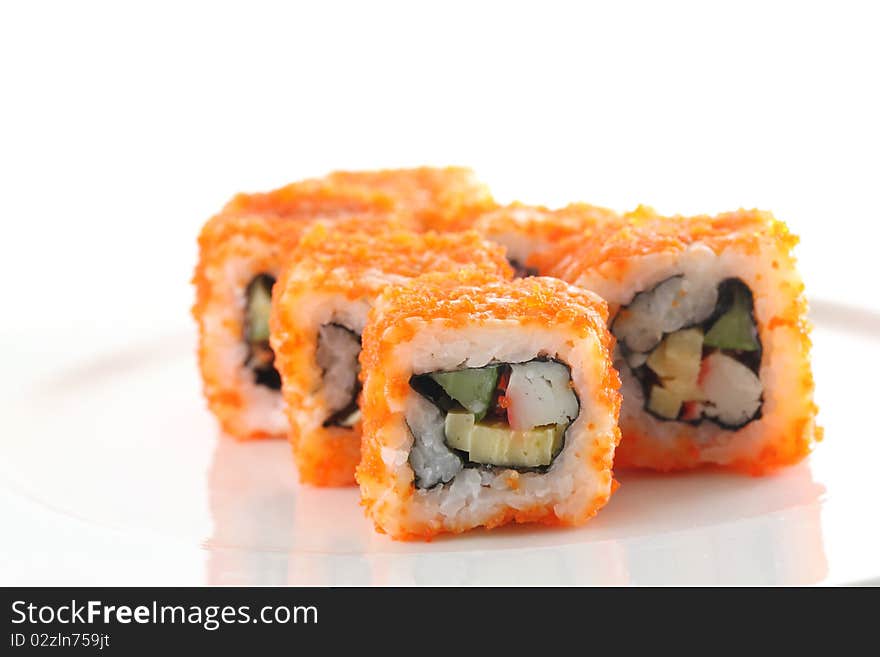 Egg imitation crabmeat cucumber tuna and salmon roll sushi in macro with white background. Egg imitation crabmeat cucumber tuna and salmon roll sushi in macro with white background