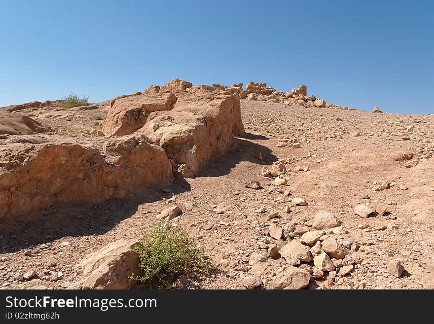 Ruined Wall Of Ancient Fortress In The Desert