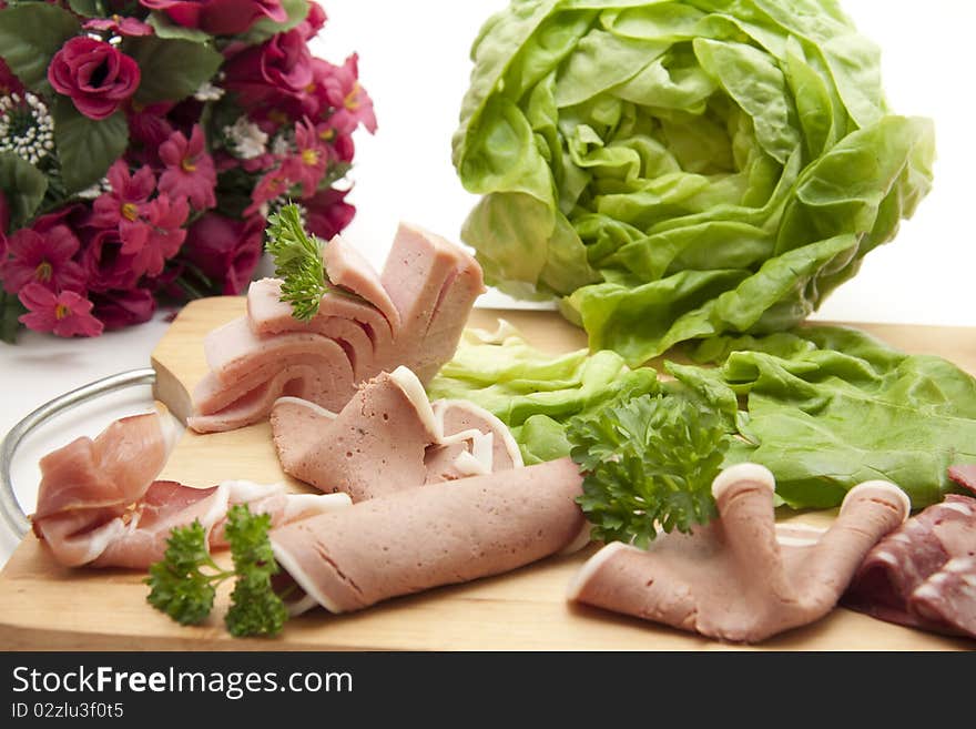 Sausage plate with salad and bunch of flowers