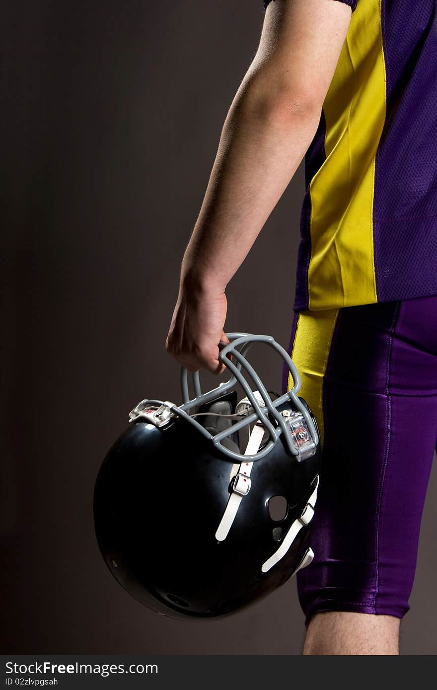 Athlete Holding Football Helmet