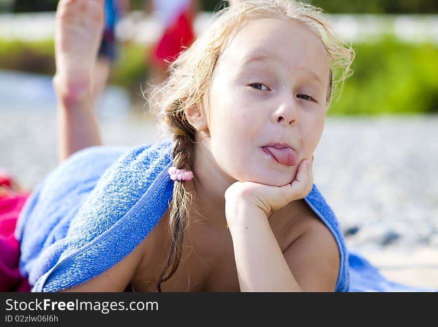 The little girl lying on the beach after swimming. The little girl lying on the beach after swimming