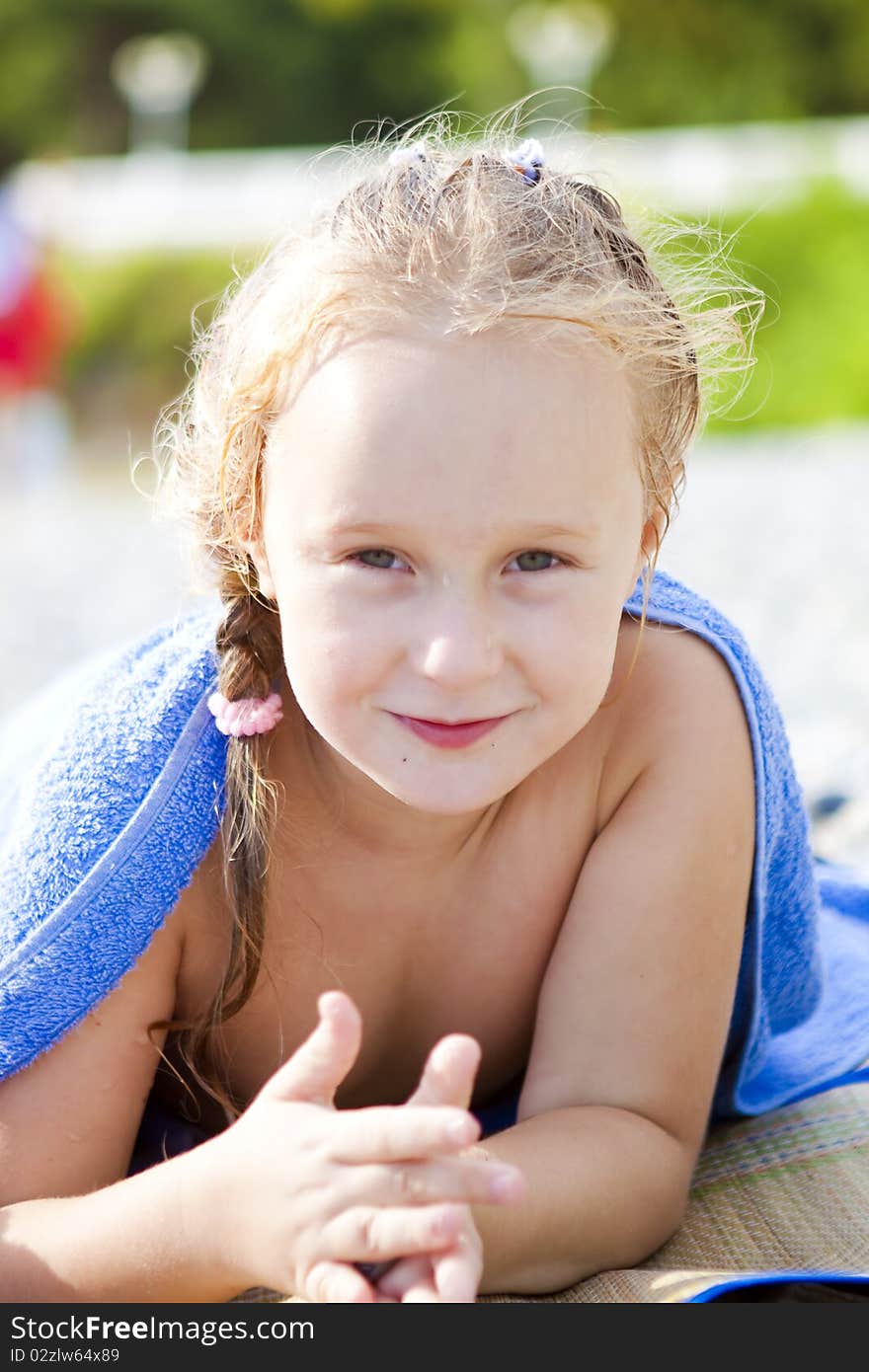 The little girl lying on the beach after swimming. The little girl lying on the beach after swimming