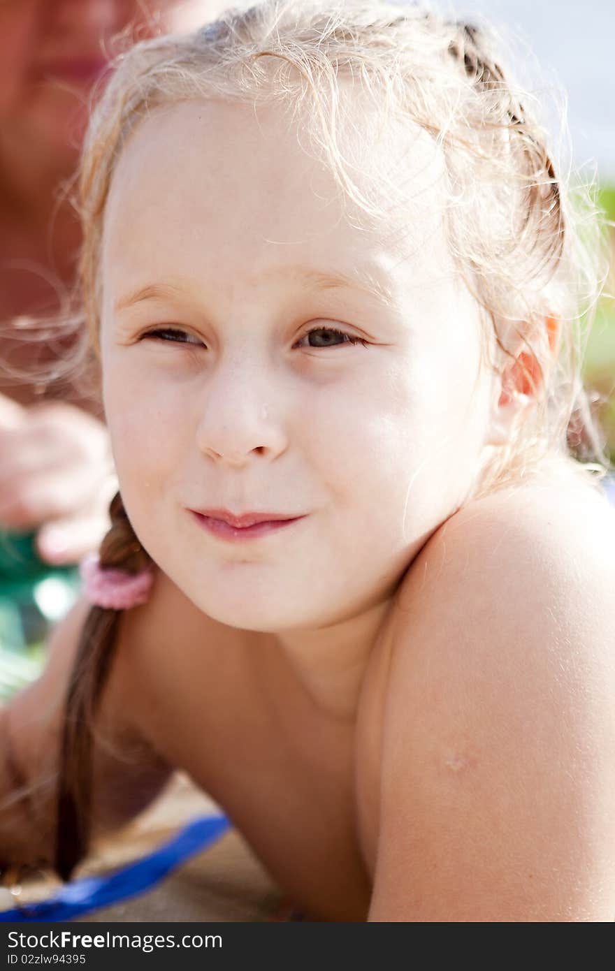 The little girl lying on the beach after swimming. The little girl lying on the beach after swimming