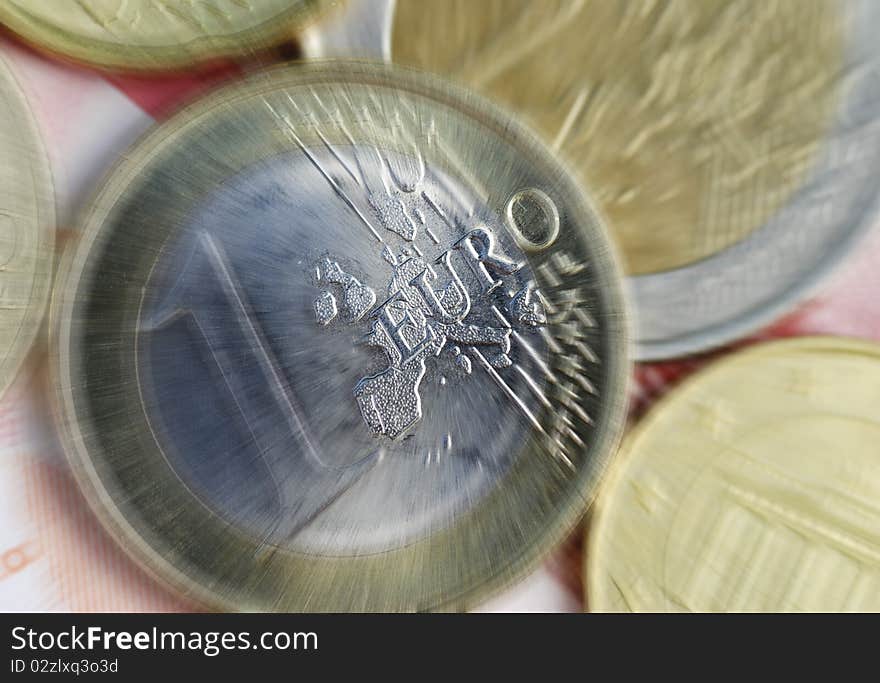 Euro coins resting on banknotes with zoom effect. Euro coins resting on banknotes with zoom effect