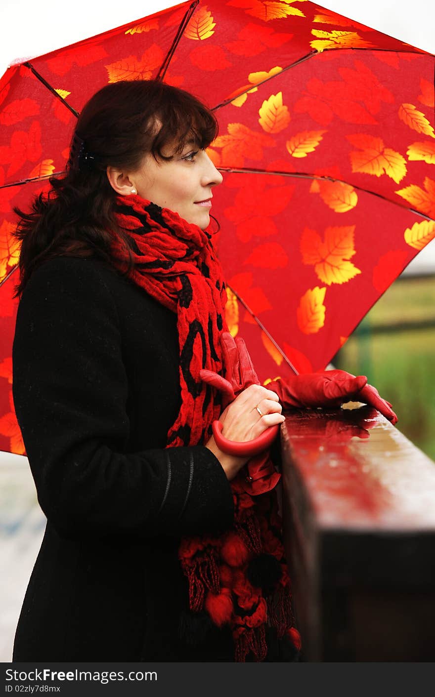 The beautiful girl with a red umbrella.