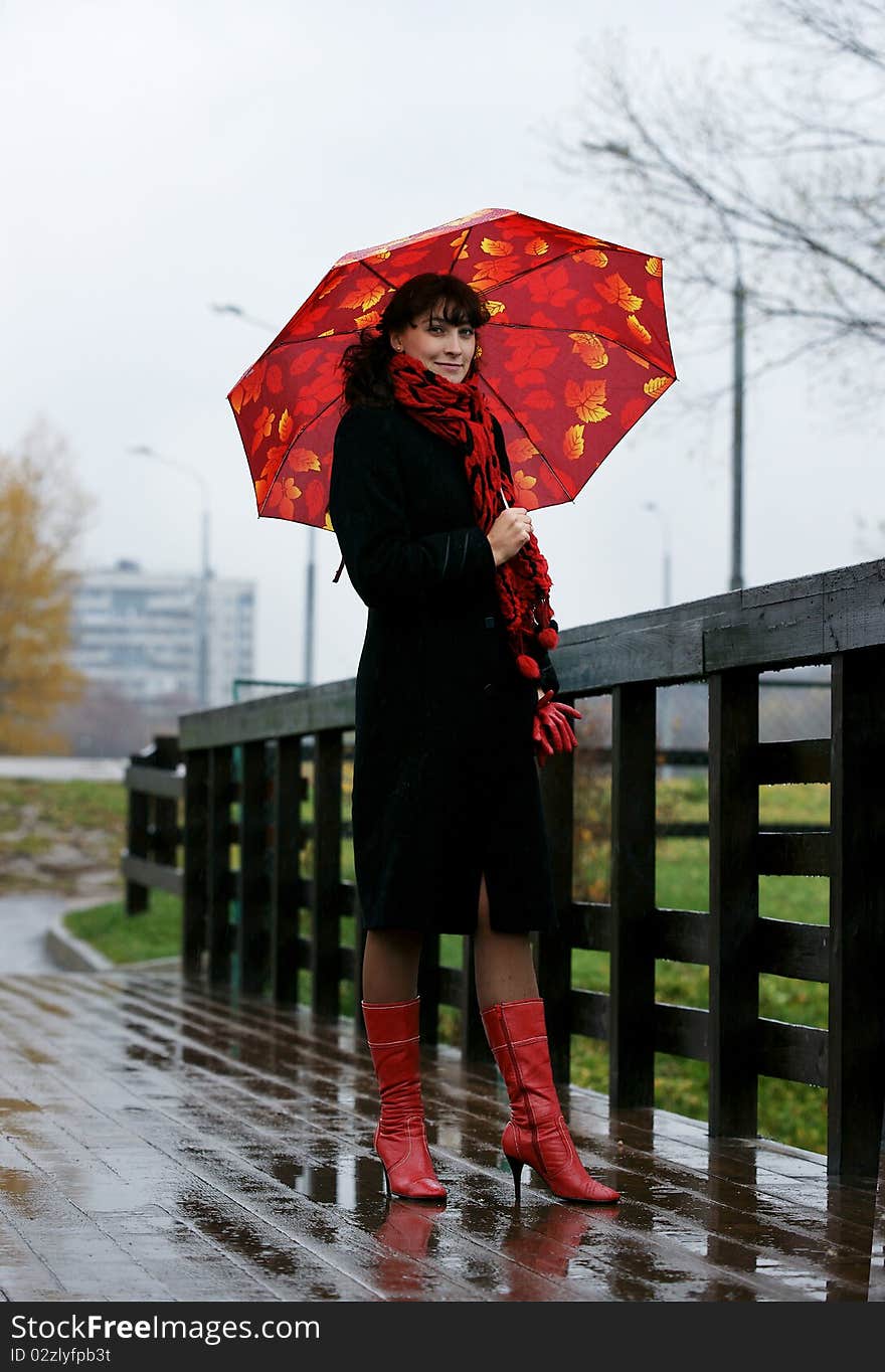 The beautiful girl with a red umbrella.