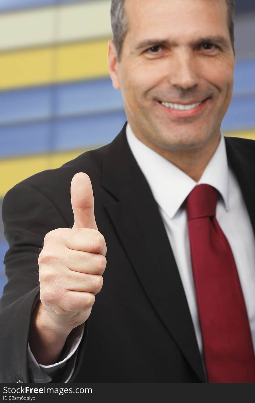 Businessman showing thumbs-up sign