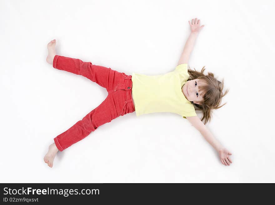 The portrait of a cute little girl standing on the floor and looking at the camera