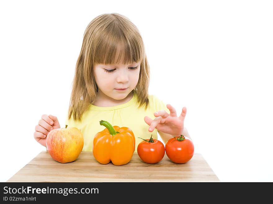 The portrait of a cute little girl holding fresh vegetables