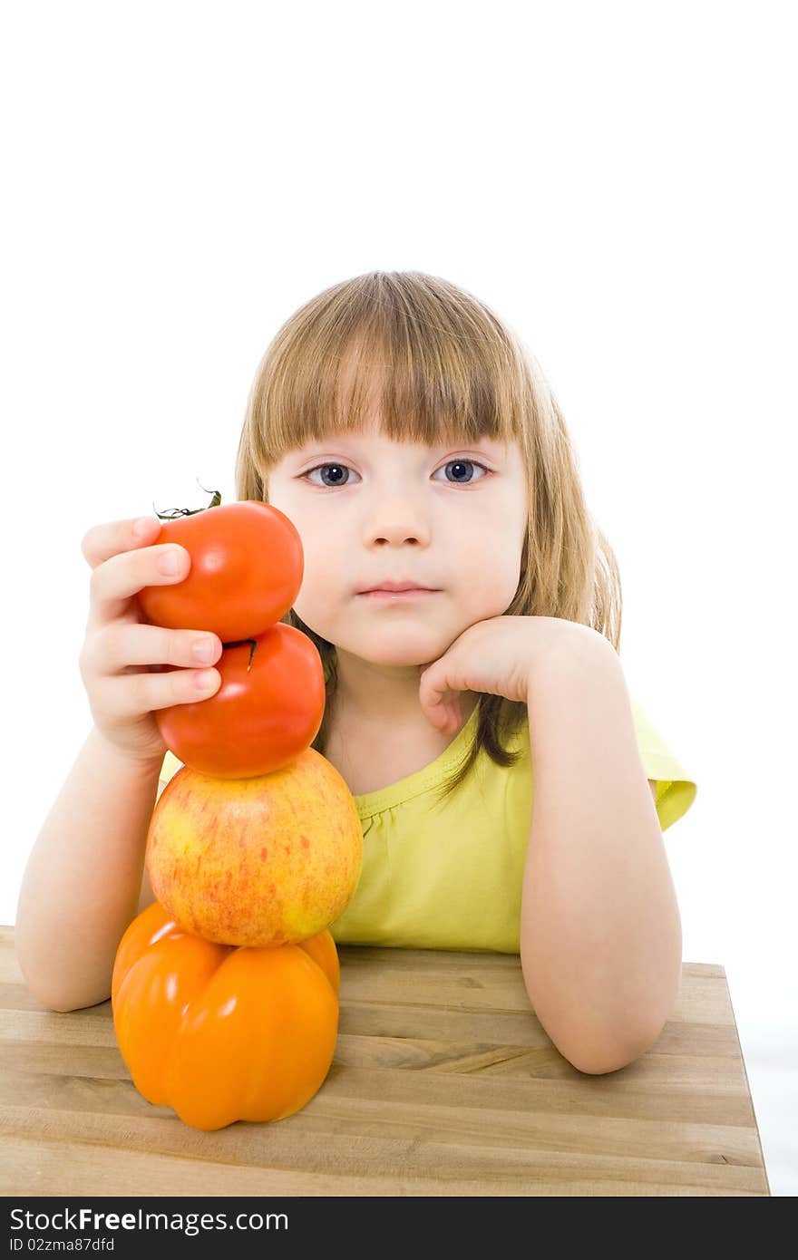 The portrait of a cute little girl holding fresh vegetables