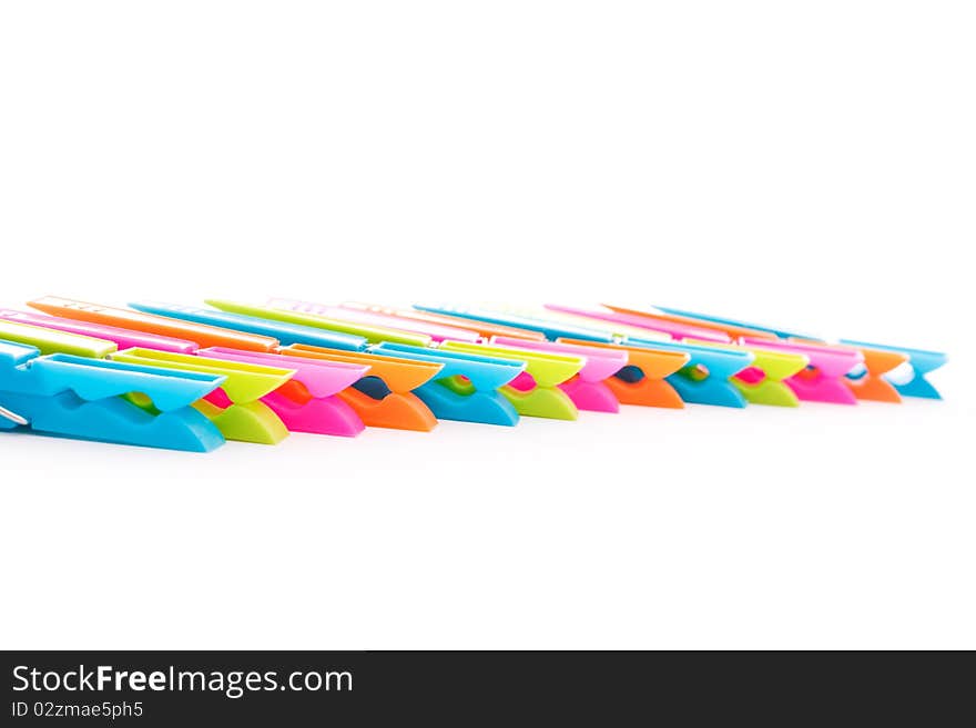 Close up shot of multicolored clothespins isolated on white